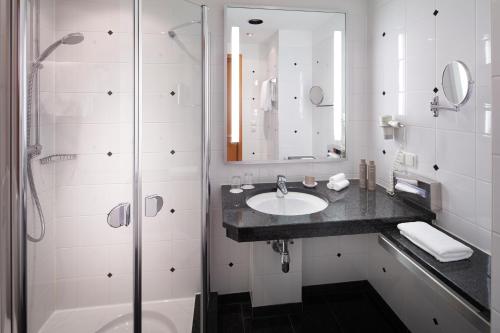 a bathroom with a sink and a shower at Parkhotel Pforzheim in Pforzheim