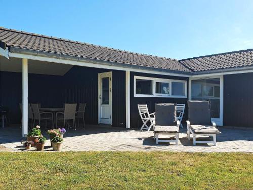 a patio with two chairs and a table and chairs at 4 person holiday home in Gilleleje-By Traum in Gilleleje