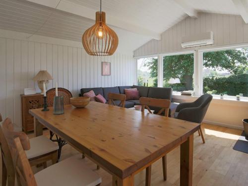 a living room with a wooden table and a couch at 4 person holiday home in Gilleleje-By Traum in Gilleleje