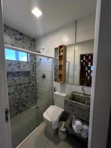a bathroom with a shower and a toilet and a sink at Pousada Águas de Maragogi in Maragogi