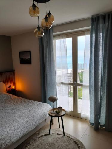 a bedroom with a bed and a window with a view at Balconi sul Lago - Stunning Lakeview and Pool in Parzanica