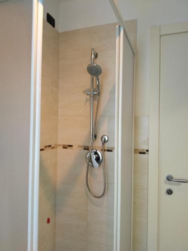 a shower with a glass door in a bathroom at Balconi sul Lago - Stunning Lakeview and Pool in Parzanica