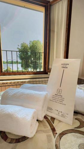 a room with two towels on a bed with a window at Residenza Bibiena in Mantova