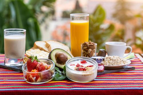 a table topped with breakfast foods and orange juice at Apartamentos da Carreira in Funchal