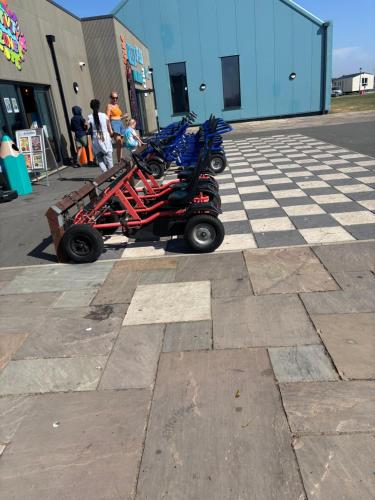 a group of scooters parked in a parking lot at Singh&Leite Family caravan for 10 people with 2toilets and lovely Decking in Jaywick Sands