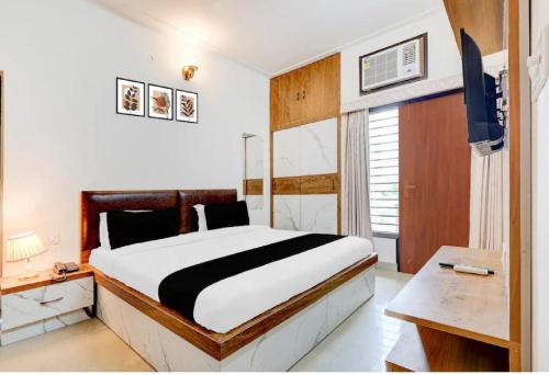 a bedroom with a large bed and a desk at Prem villas homestay in Tājganj