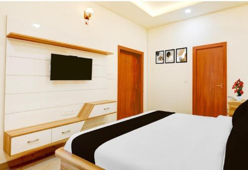 a bedroom with a bed and a flat screen tv at Prem villas homestay in Tājganj