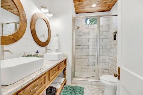 a bathroom with a sink and a shower at Luxury Combo Walk to Main with 2 Hot-Tubs in Fredericksburg