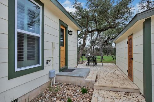 a house with a door and a patio at Upscale Home with Pool and FirePit - Close to Mercer St! in Dripping Springs