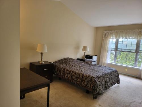 a bedroom with a bed and a window at Smart Home Near You in Springdale