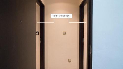 a door with a sign that reads conference rooms at Hotel Calmo Hamilton in Singapore