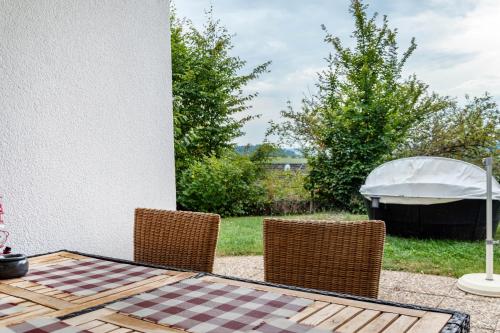 a table and chairs with a gazebo in a yard at Ferienwohnung Brenda in Schillingsfürst