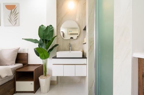a bathroom with a sink and a mirror at Ekomo Home 95 - Metro Ben Thanh in Ho Chi Minh City