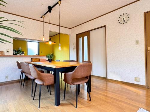 a dining room with a table and chairs at OKA Stay OKAYAMA in Okayama