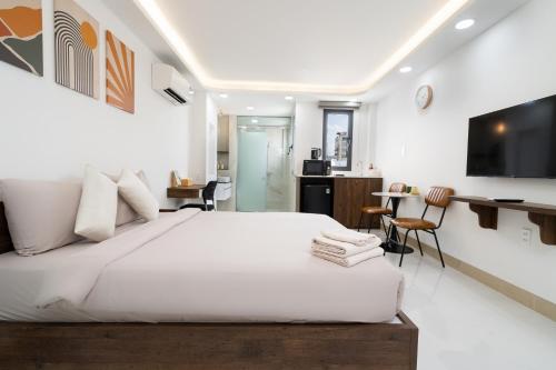 a bedroom with a large bed and a living room at Ekomo Home 95 - Metro Ben Thanh in Ho Chi Minh City