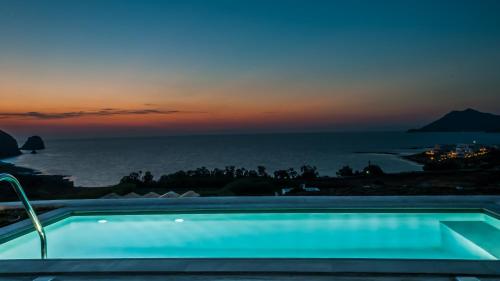 a swimming pool with a view of the ocean at Milos Breeze Boutique Hotel in Pollonia