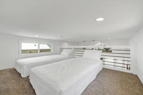 a white bedroom with two beds and a window at Resort at Fredericksburg Unit 28 in Rocky Hill
