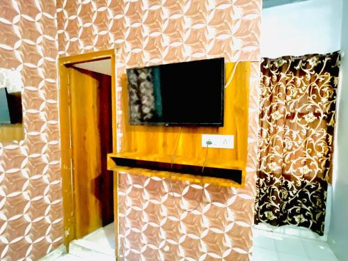 a room with a tv on a wall at Diamond Inn - 50 Mtrs Near Golden Temple in Amritsar