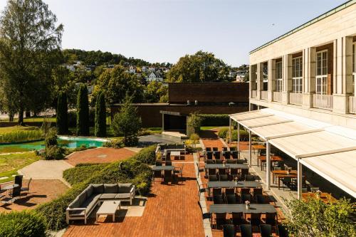 an overhead view of a building with tables and chairs at Scandic Park Sandefjord in Sandefjord