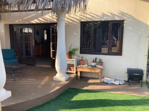 a porch of a house with a table and chairs at Savaneta house in Savaneta