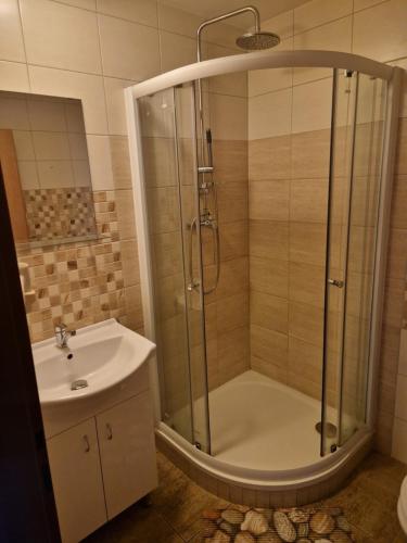 a bathroom with a shower and a sink at Penzion Kornout in Bílina