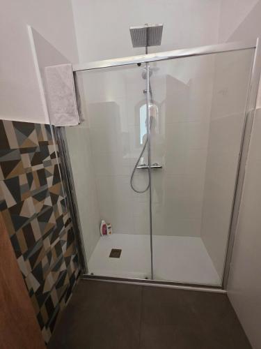 a shower with a glass door in a bathroom at Villa Giacoma hot tub and garden in Mandra Capreria