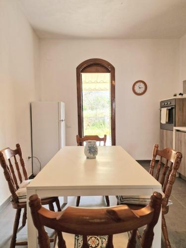 a kitchen with a table with chairs and a refrigerator at Villa Giacoma hot tub and garden in Mandra Capreria