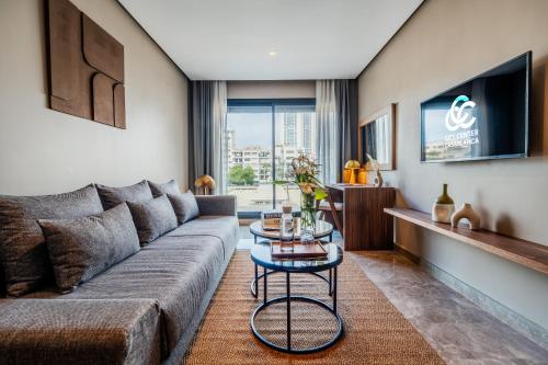 a living room with a couch and a table at Casablanca City Center Maarif in Casablanca