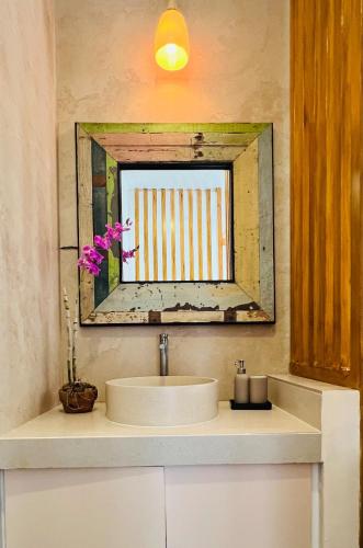 a bathroom with a sink and a mirror at Maquiling Resthouse in Los Baños