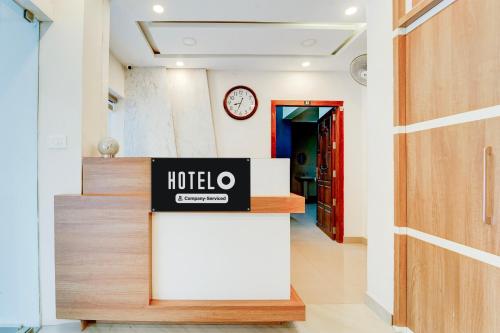 a hotel lobby with a hotel sign on a counter at Super Hotel O Kazhakootam Near Technopark Phase 2 in Trivandrum