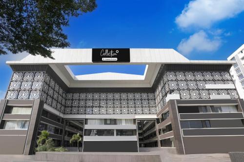 an office building with a sign on it at Super Collection O Vesu Surat Formerly Hotel Signature in Surat