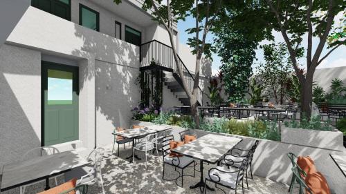 a patio with tables and chairs next to a building at Kentrikon 1924 Boutique Hotel, Paphos Old Town in Paphos City