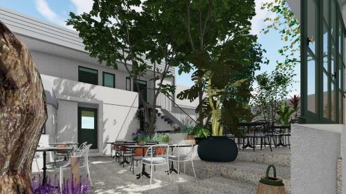 a courtyard with tables and chairs and a tree at Kentrikon 1924 Boutique Hotel, Paphos Old Town in Paphos City