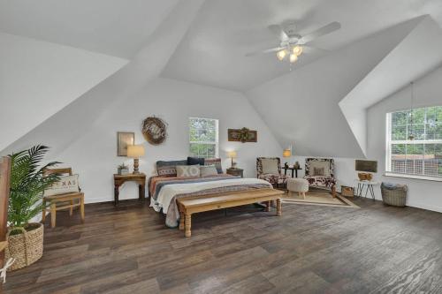 a bedroom with a bed and a ceiling fan at Cactus Flower Treehouse-Pet Friendly-Hill Country Views! in Luckenbach