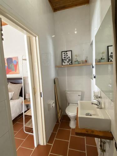 a bathroom with a white toilet and a sink at House Cosy in Northriding