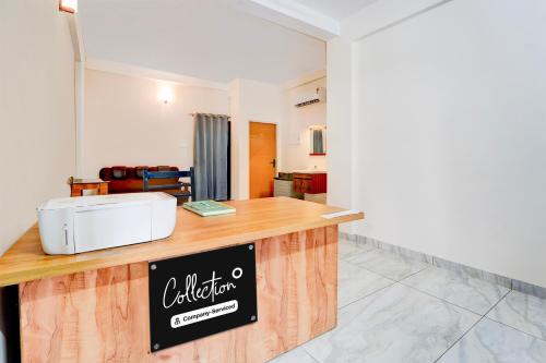 a kitchen with a counter with a sign on it at Super Collection O Westhill Near Govt Engg College in Calicut