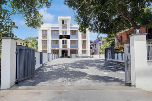 an empty street in front of a white building at Super Collection O Westhill Near Govt Engg College in Calicut