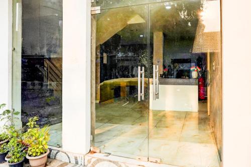 a glass door of a store with a room at Super Collection O Vasundhara Enclave Delhi in Noida