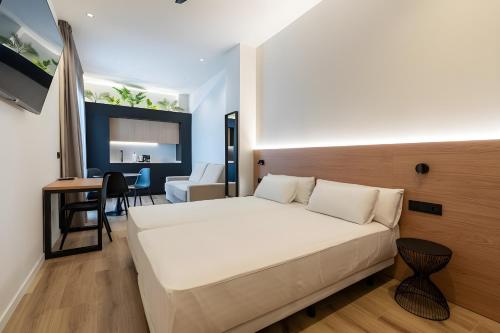 a bedroom with a bed and a desk in a room at Cool Lofts Boutique Castellón in Castellón de la Plana