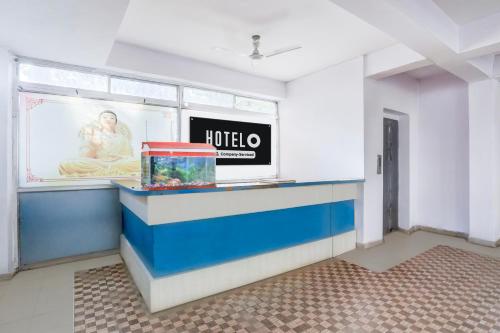 a room with a large picture of a woman at Super Hotel O Rajeev Nagar Formerly Happy Journey in Patna