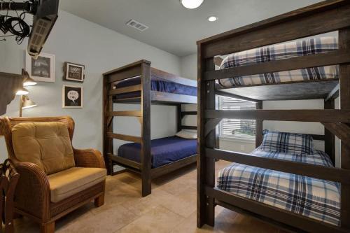 a room with two bunk beds and a chair at Let's Go Tubing! Awesome House-Next to River! in Third Crossing
