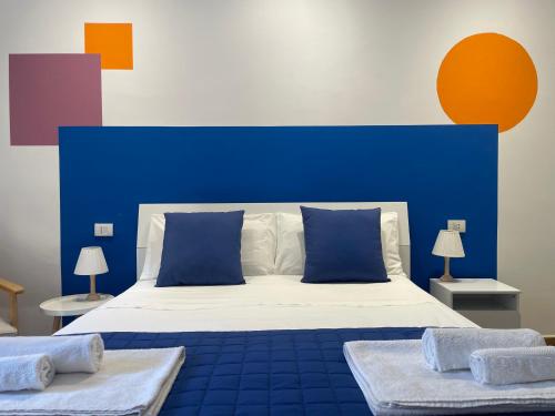 a bedroom with a blue and white bed with two tables at Borgo Minore in Montefiascone