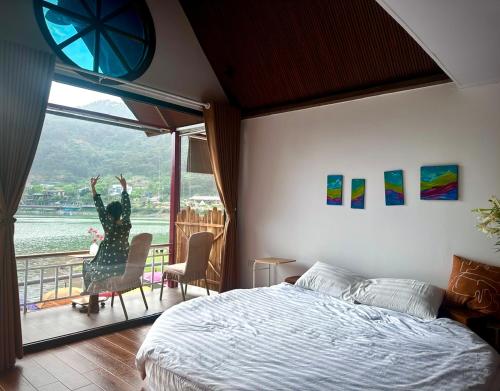 a bedroom with a bed and a view of the water at Nhà Ven Hồ Đồng Đò, Minh Trí, Sóc Sơn, Hà Nội in Hanoi
