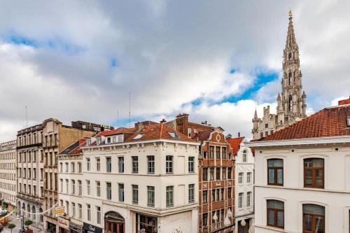 a group of buildings in a city with a clock tower at Exclusive 2BR with UNESCO Views in Brussels