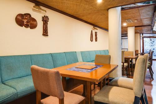a dining room with a wooden table and chairs at Palette MG Road Ernakulam Formerly Harbour View Residency in Cochin