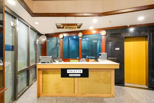 a waiting room with a station with a yellow door at Palette MG Road Ernakulam Formerly Harbour View Residency in Cochin