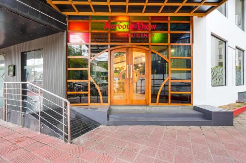 a door to a restaurant with a sign on it at Palette MG Road Ernakulam Formerly Harbour View Residency in Cochin