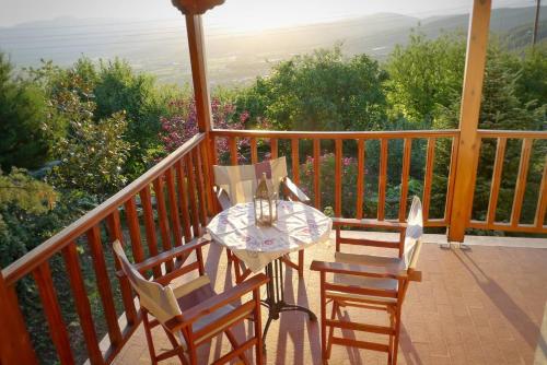 a table and chairs on a balcony with a view at Penelope's house in Konitsa