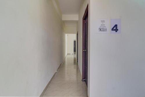 an empty hallway with a door in a building at Super Collection O Manikonda in Hyderabad