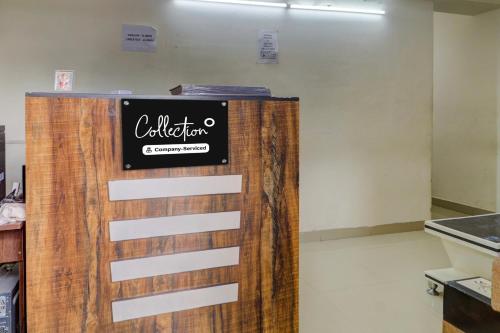 a sign on a wooden door in a room at Super Collection O Manikonda in Hyderabad